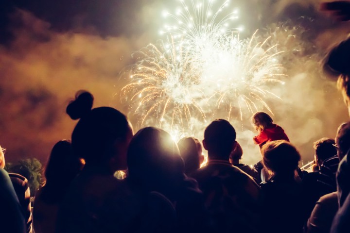 a group of people watching fireworks