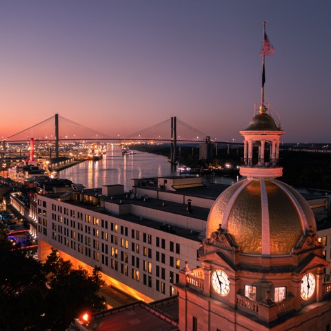 a large clock tower towering over the city of Savannah