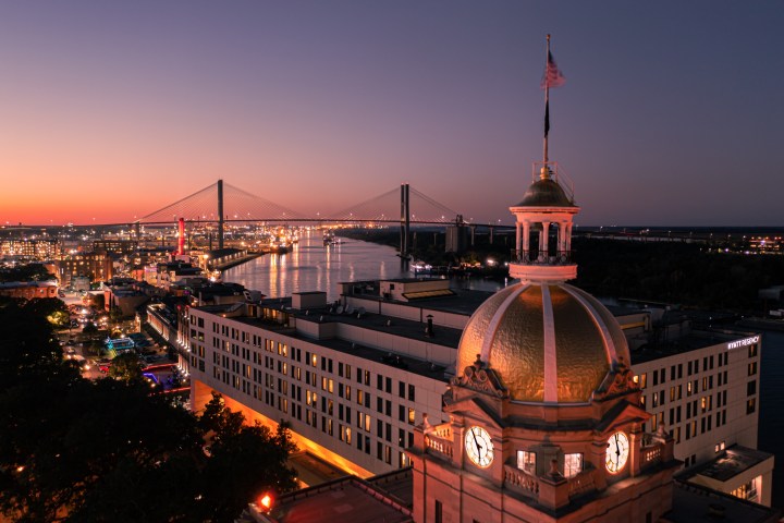 a large clock tower towering over the city of Savannah