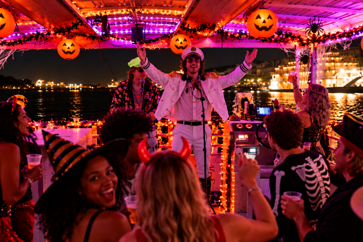 Halloween party on a decorated boat with people in costumes.